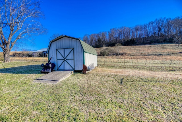 view of outbuilding featuring a yard and a rural view