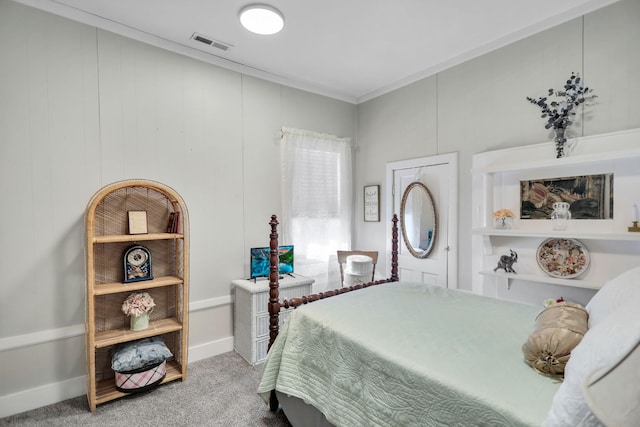 bedroom with crown molding and carpet