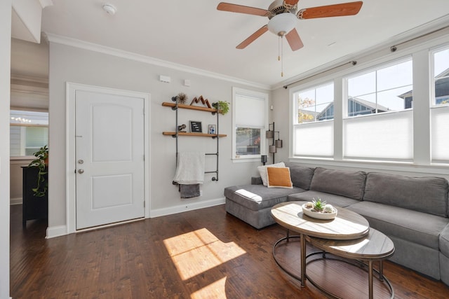 living area featuring dark wood-type flooring, crown molding, baseboards, and ceiling fan