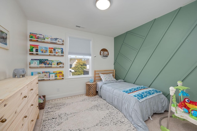 carpeted bedroom with visible vents and baseboards