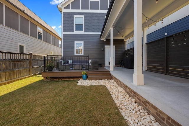 rear view of house featuring a yard, a patio area, fence, and a deck