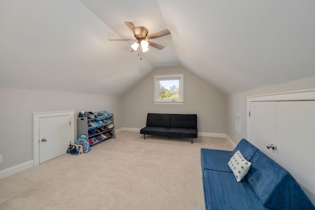 sitting room featuring vaulted ceiling, light carpet, and baseboards