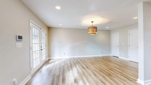 unfurnished room featuring light hardwood / wood-style flooring and french doors