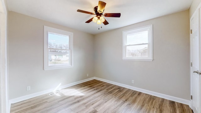 empty room with light hardwood / wood-style flooring and ceiling fan