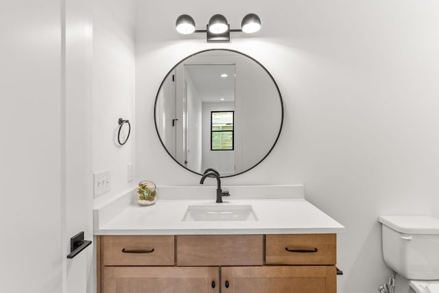 bathroom featuring vanity and toilet