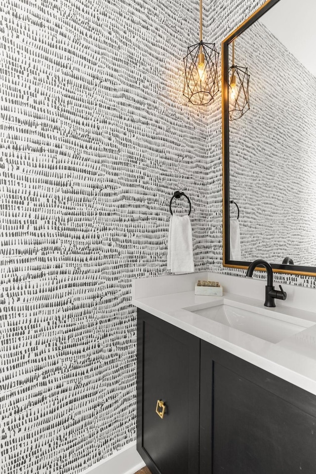 bathroom with vanity and tile walls