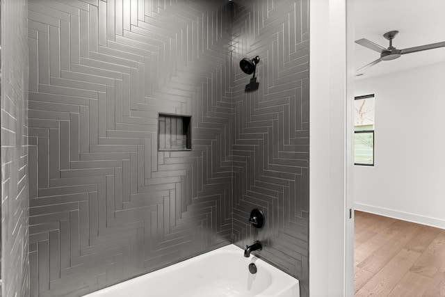 bathroom featuring tiled shower / bath combo, wood-type flooring, and ceiling fan