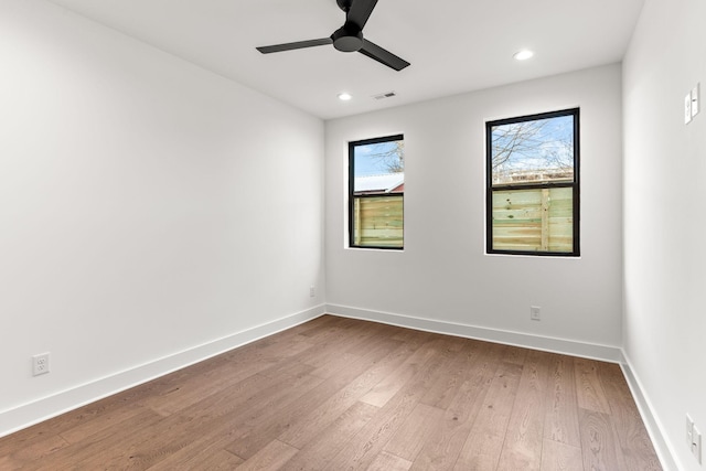 spare room with wood-type flooring and ceiling fan