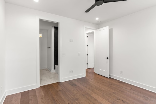 unfurnished bedroom with ceiling fan and dark hardwood / wood-style flooring