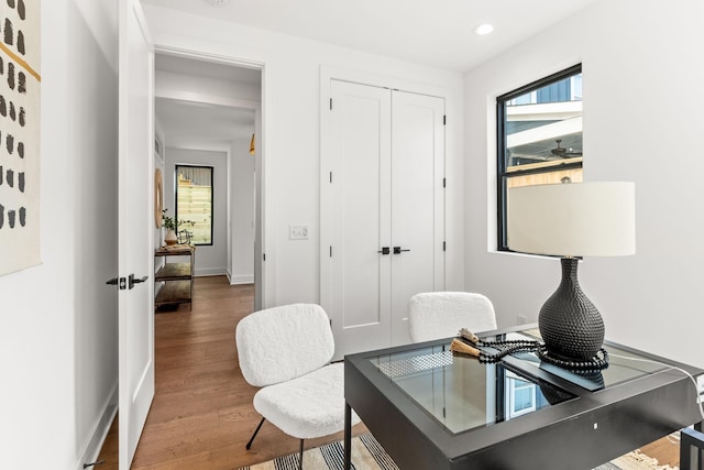 home office with hardwood / wood-style floors