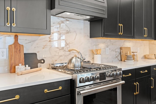 kitchen featuring tasteful backsplash, premium range hood, and stainless steel range with gas stovetop