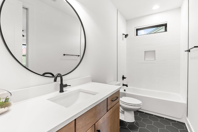 full bathroom with tiled shower / bath, vanity, toilet, and tile patterned flooring