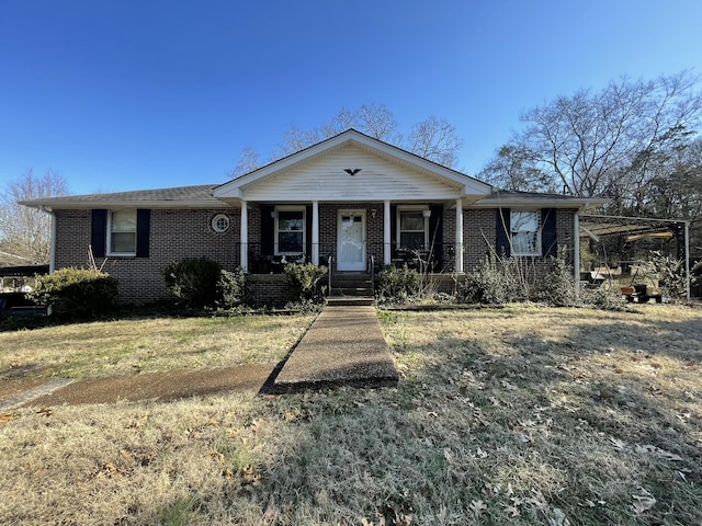 ranch-style house with a porch and a front yard