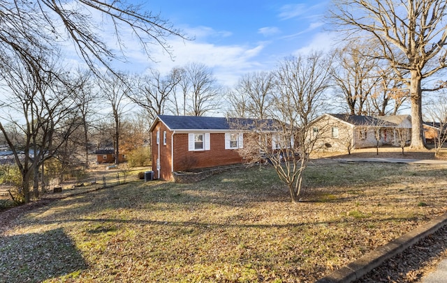 view of front facade with central AC and a front yard