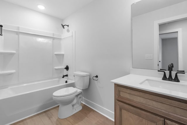 full bathroom with vanity, hardwood / wood-style floors, toilet, and shower / bath combination