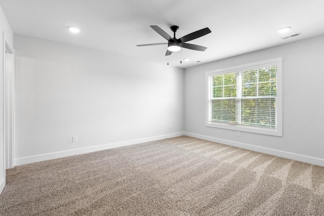 carpeted spare room with ceiling fan