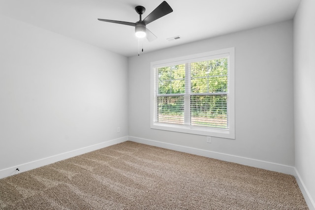 carpeted empty room featuring ceiling fan