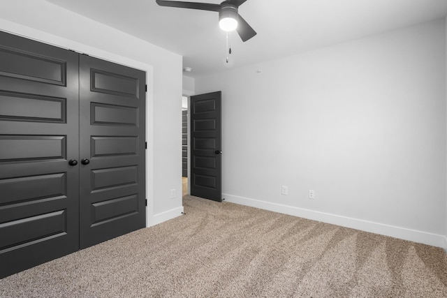 unfurnished bedroom featuring ceiling fan, carpet flooring, and a closet