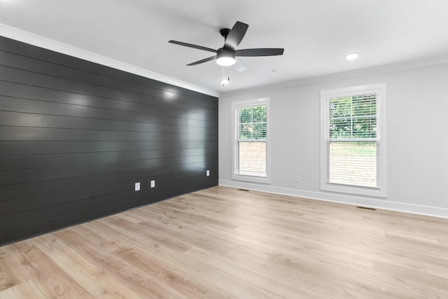 unfurnished room featuring ornamental molding, ceiling fan, and light hardwood / wood-style flooring