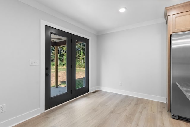 doorway to outside featuring crown molding, light hardwood / wood-style flooring, and a wealth of natural light