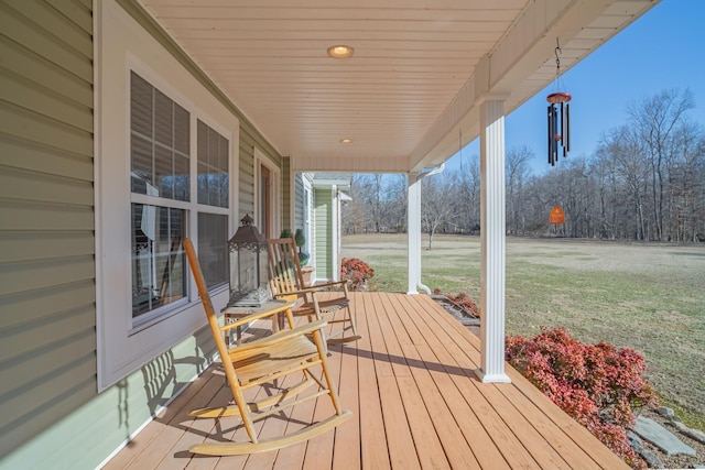 deck featuring a yard and a porch