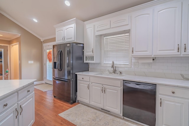 kitchen featuring sink, white cabinetry, ornamental molding, black appliances, and light hardwood / wood-style floors