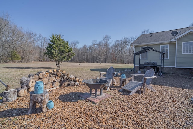 view of yard with a fire pit