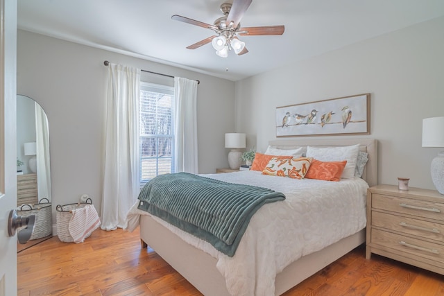 bedroom with hardwood / wood-style floors and ceiling fan