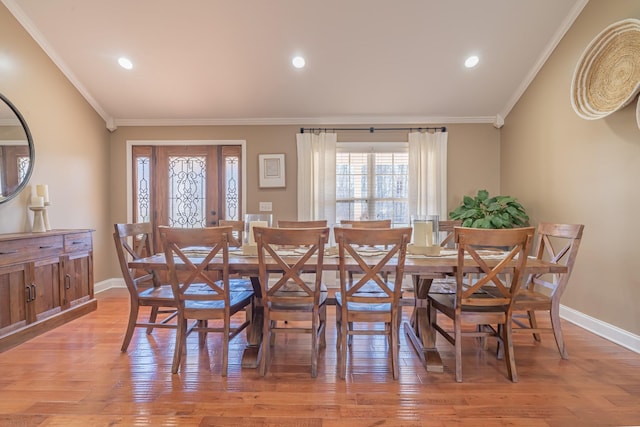 dining space featuring light hardwood / wood-style flooring and ornamental molding