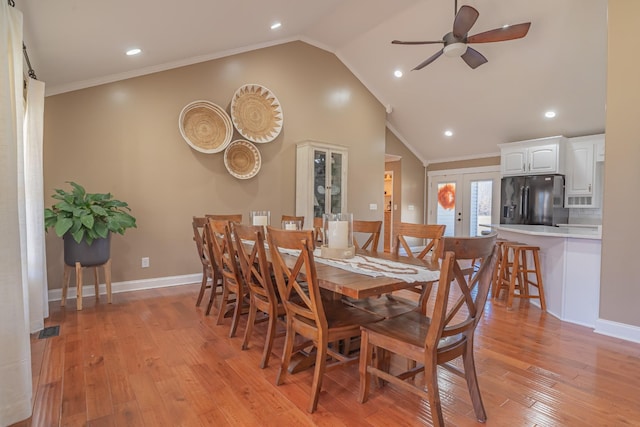 dining space with french doors, crown molding, vaulted ceiling, light wood-type flooring, and ceiling fan