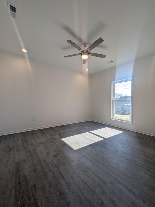 empty room featuring dark hardwood / wood-style flooring and ceiling fan