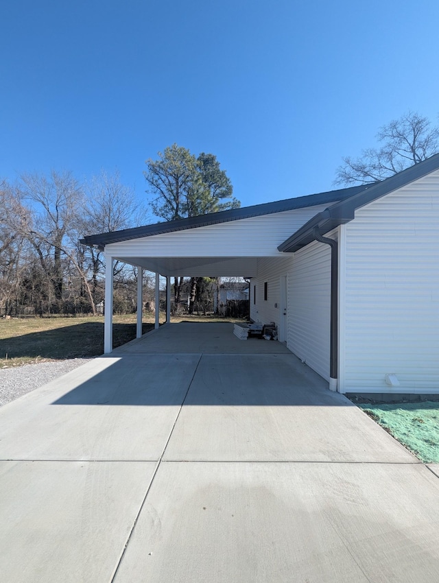 view of parking / parking lot featuring a carport