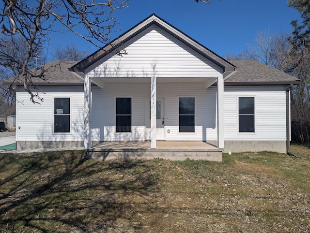 back of house featuring a porch and a lawn