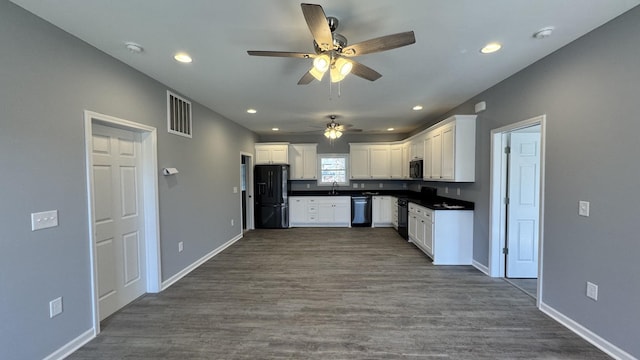 kitchen featuring sink, white cabinets, dark hardwood / wood-style flooring, and black appliances