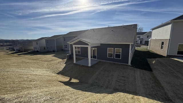 back of house with a lawn