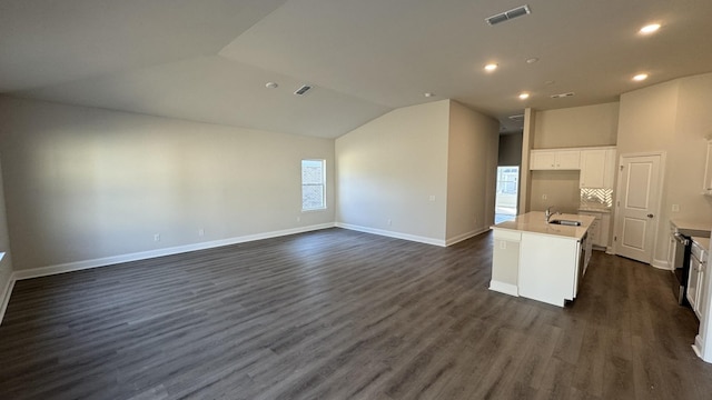 interior space featuring dark hardwood / wood-style flooring, sink, and vaulted ceiling