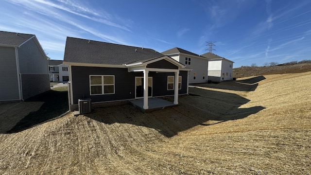 rear view of property with cooling unit and a patio