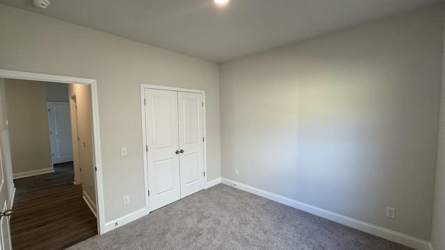 unfurnished bedroom featuring carpet flooring and a closet