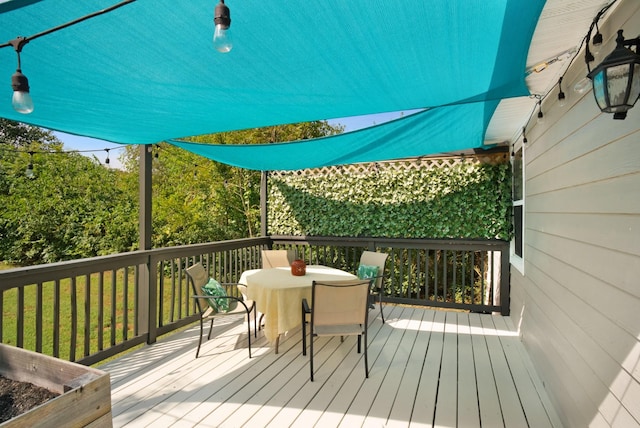 wooden deck featuring outdoor dining space