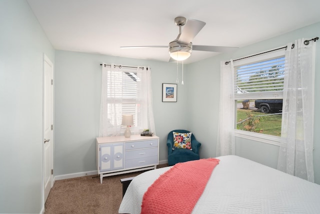 bedroom featuring ceiling fan and dark colored carpet