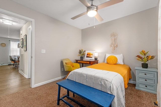 bedroom with baseboards, attic access, ceiling fan, and carpet flooring