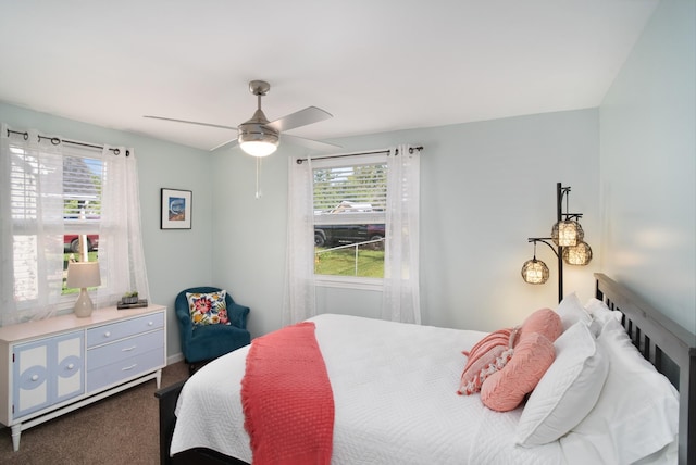 bedroom featuring dark carpet and ceiling fan