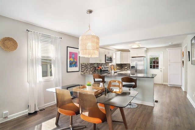 dining space with sink and dark hardwood / wood-style flooring