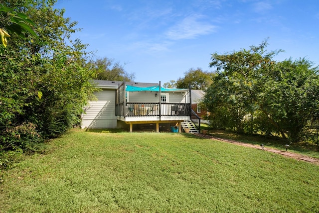 back of house featuring a wooden deck and a lawn