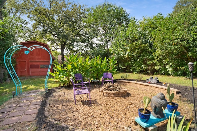 view of yard with an outdoor structure and a fire pit