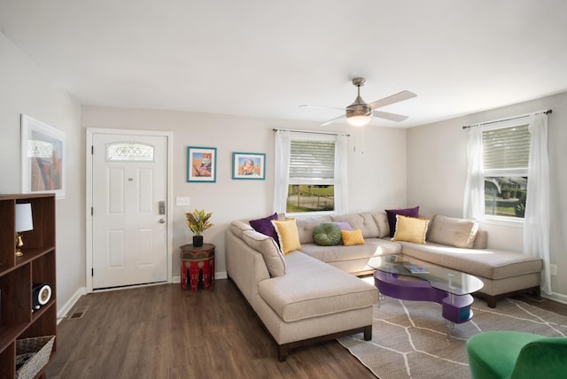 living area featuring ceiling fan, baseboards, and wood finished floors