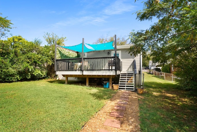 back of property with a lawn, a deck, stairs, and fence