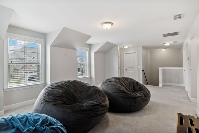 sitting room featuring light colored carpet