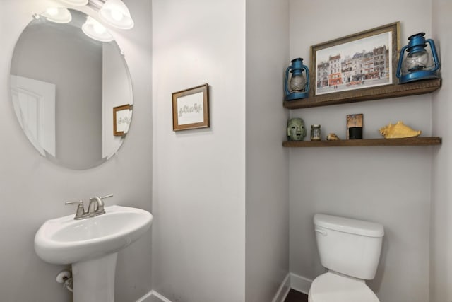 bathroom featuring toilet and sink