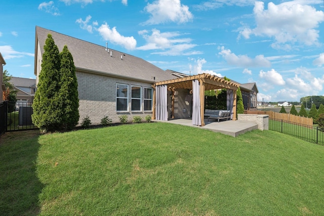 back of house with a pergola, a patio area, and a lawn